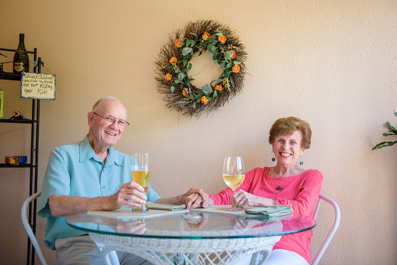 Senior couple drinking wine and beer on patio