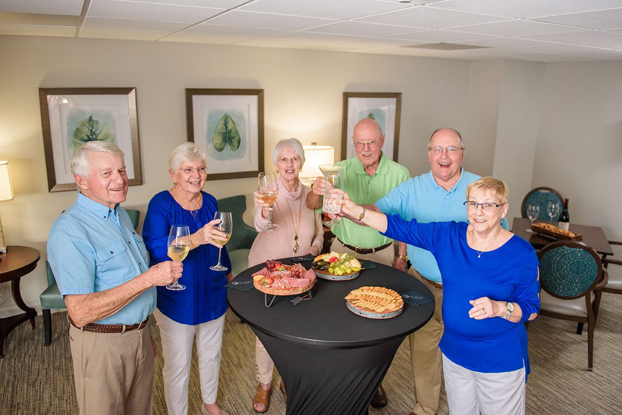 Senior couples at happy hour with wine and food