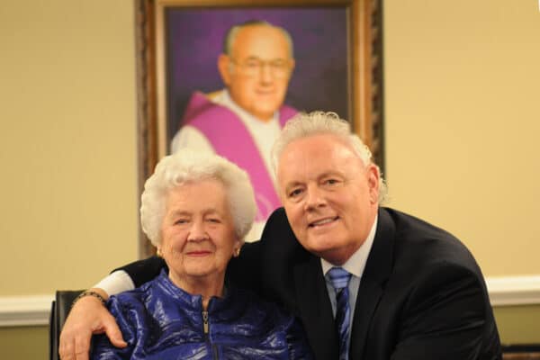 A man and an older woman posing for a photo.