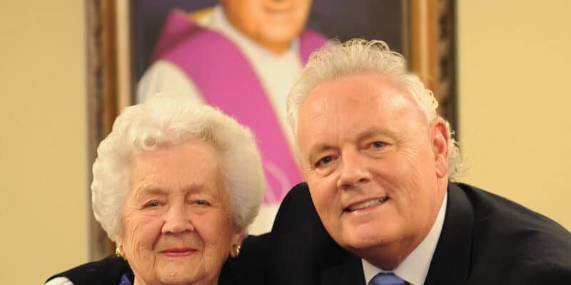 A man and an older woman posing for a picture.