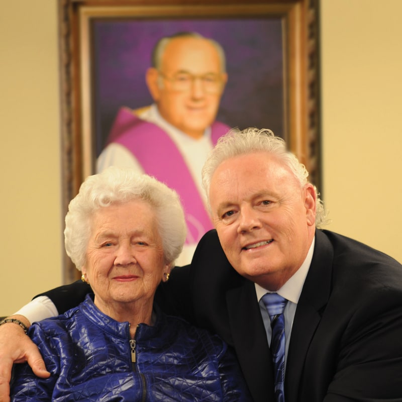 A man and an older woman posing for a picture.