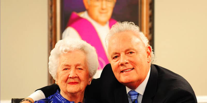 A man and an older woman posing for a picture.