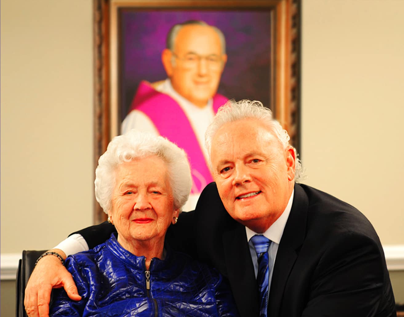 A man and an older woman posing for a picture.