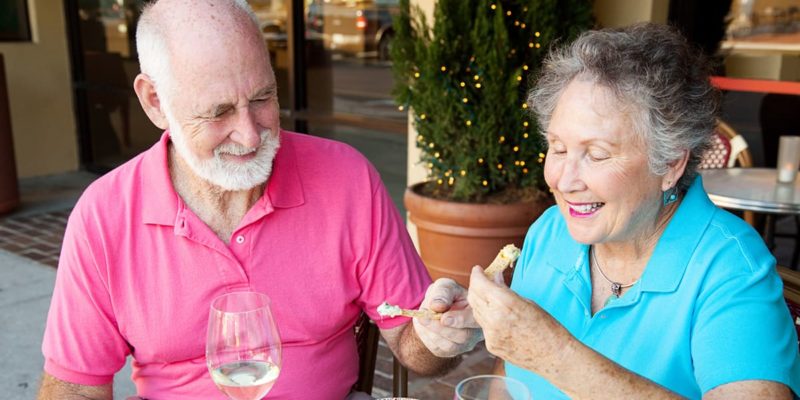 An older couple dining at an outdoor restaurant in Palm Harbor.