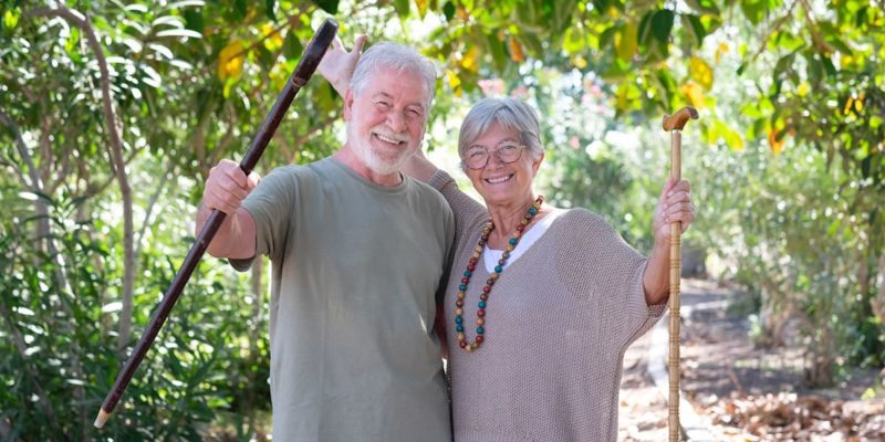 Description: An older couple reaping the benefits of getting outdoors in a forest.
        
        Keywords: Benefits, outdoors