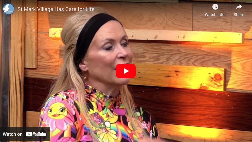 A woman wearing a colorful headband is talking on a video, discussing the life care promise.