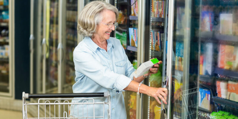 Elder women grocery shopping and reviewing the nutrition labels