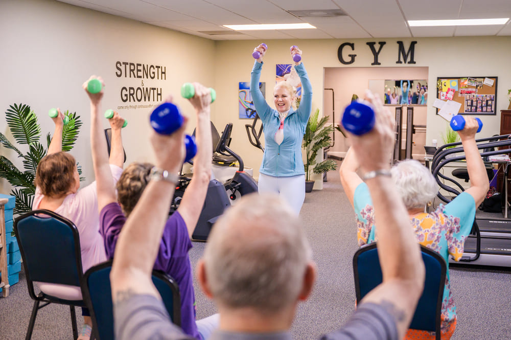 St Mark Village Lifestyle, a group of people doing exercises in a gym.