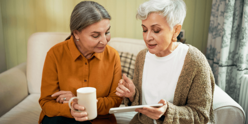 Two elder woman on a sofa discussing in senior living lifestyle is what they really want.