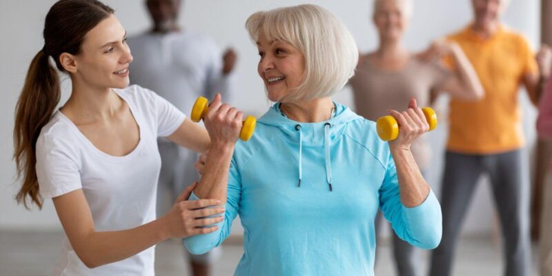 Senior group of solo agers in an exercising class.