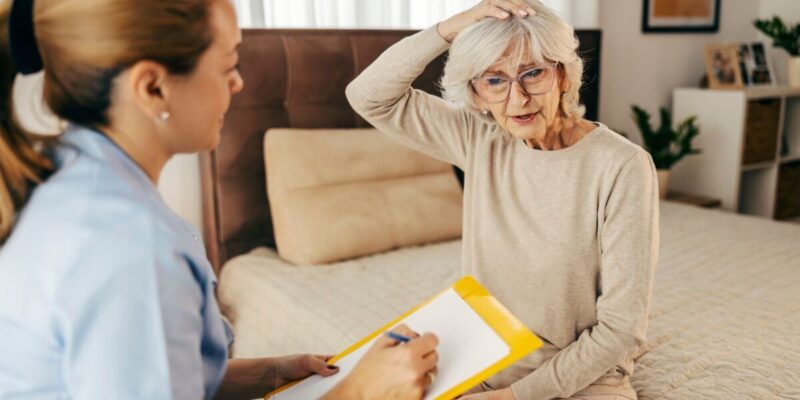 Senior woman looking at different care options with adult woman.