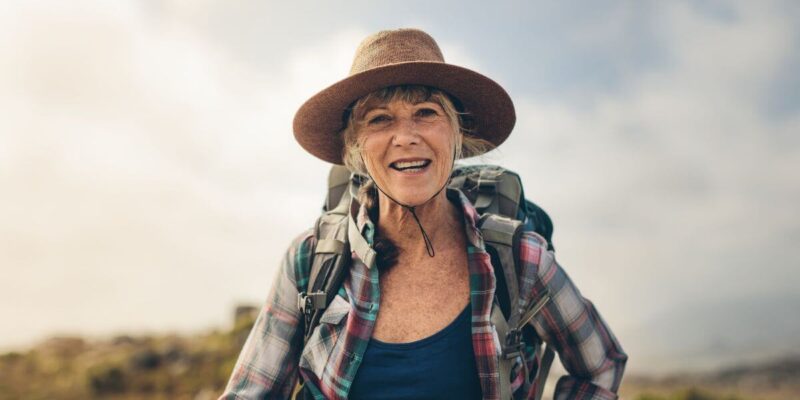 Elder woman outdoors for a hike a solo ager.