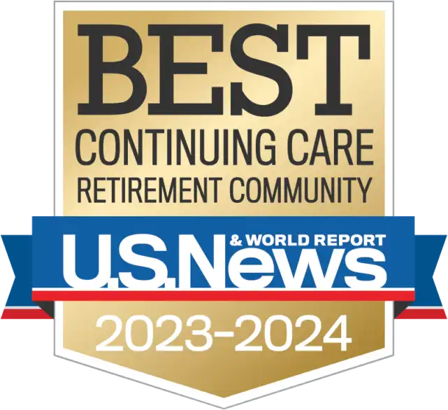 Gold and blue badge reading “Best Continuing Care Retirement Community, U.S. News & World Report, 2023-2024.” Recognizing St. Mark Village for excellence in senior living.