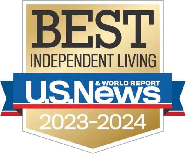 A gold badge reads "Best Independent Living U.S. News & World Report 2023-2024" in black, white, and blue text, showcasing St. Mark Village as a leader in senior living.