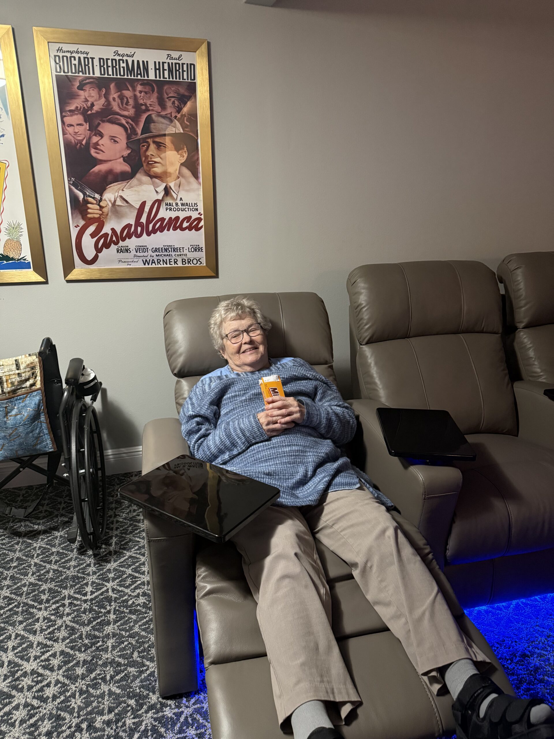 St. Mark Village resident enjoying the new movie theatre within the community