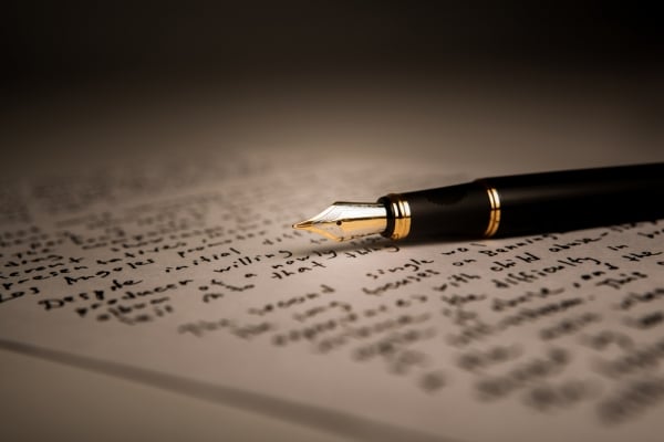 A black and gold fountain pen rests on a handwritten letter with cursive text, captured in warm lighting—a perfect reflection of the thoughtful connections celebrated at St. Mark Village senior living.